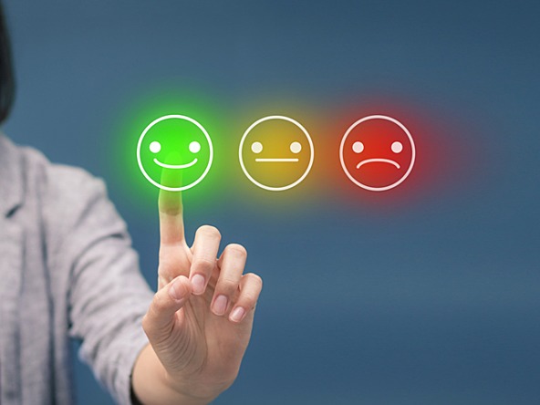 Consumer pressing satisfaction buttons to rate a brand, ranging from bad and acceptable to good